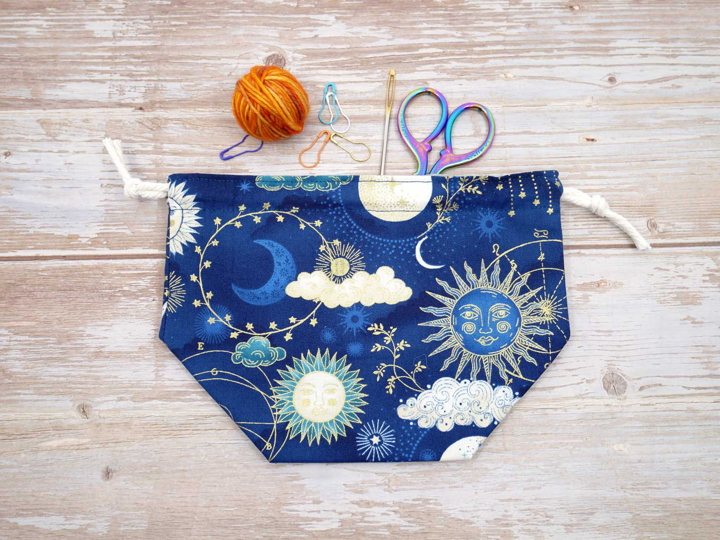 navy and gold celestial sun moon and stars drawstring pouch for knitting and crochet yarn bowl