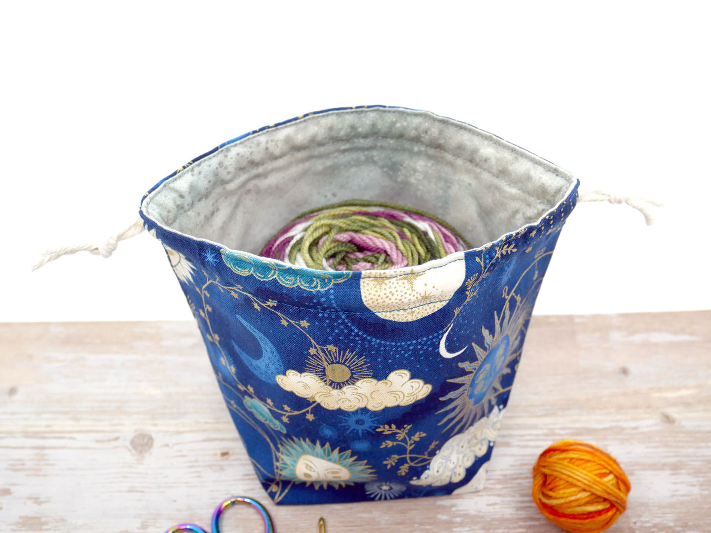 navy and gold celestial sun moon and stars drawstring pouch for knitting and crochet yarn bowl