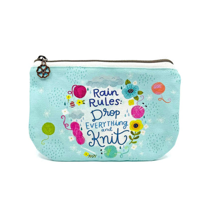 blue green canvas zippered pouch printed with yarn and flowers that says "rain rules drop everything and knit" 